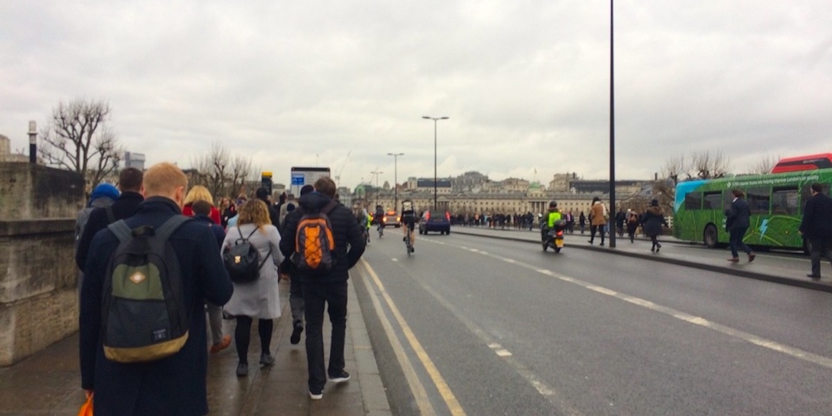 Tube strike London walkers on bridge