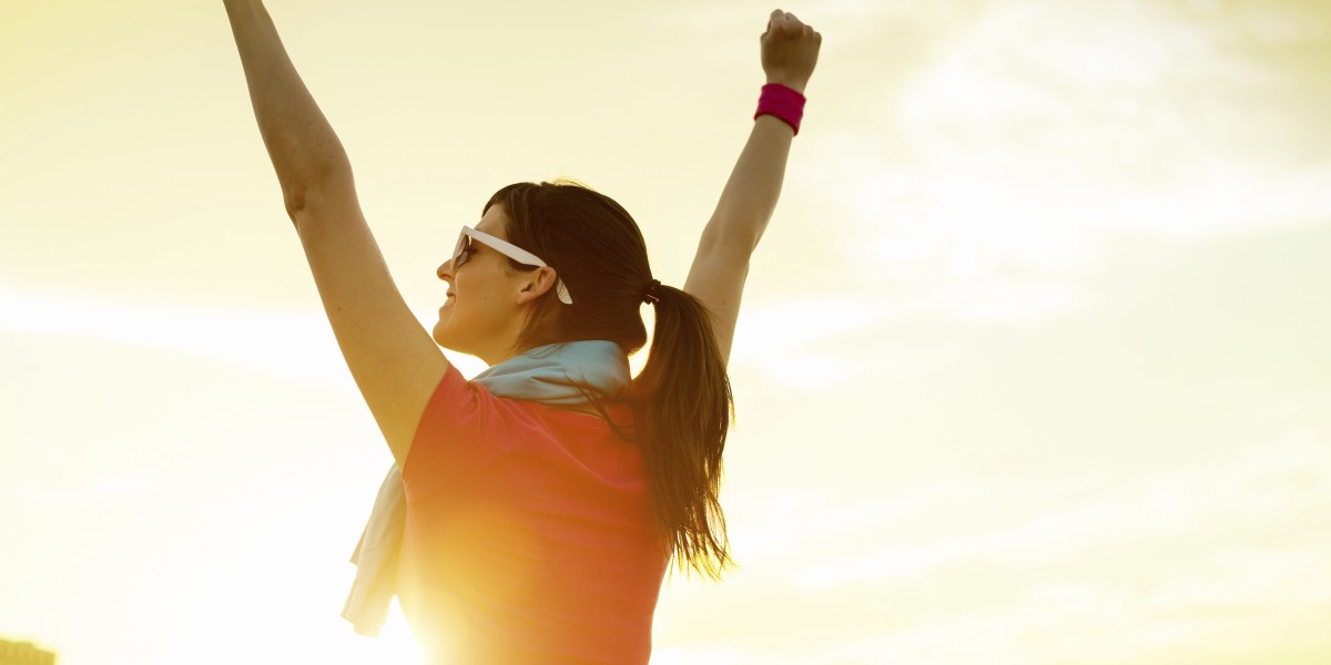 Sportswoman with arms up celebrating success