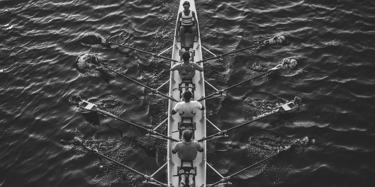 Team rowing together